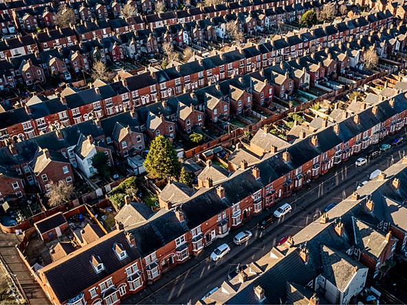 aerial view of red brick houses, streets and cars in england
